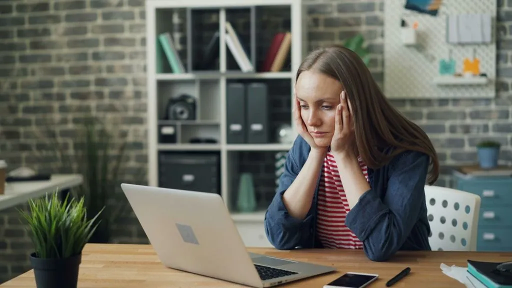 cognitive load - woman looking concentrated at computer screen